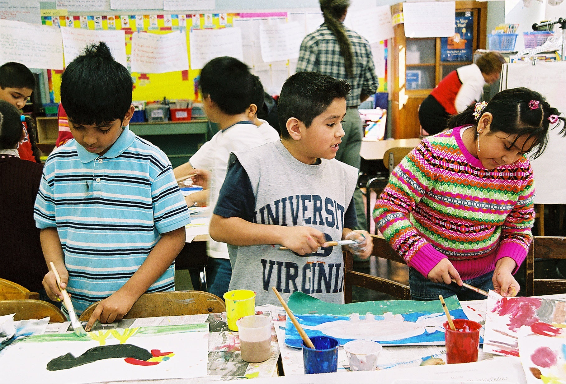 Three students work on their artwork.