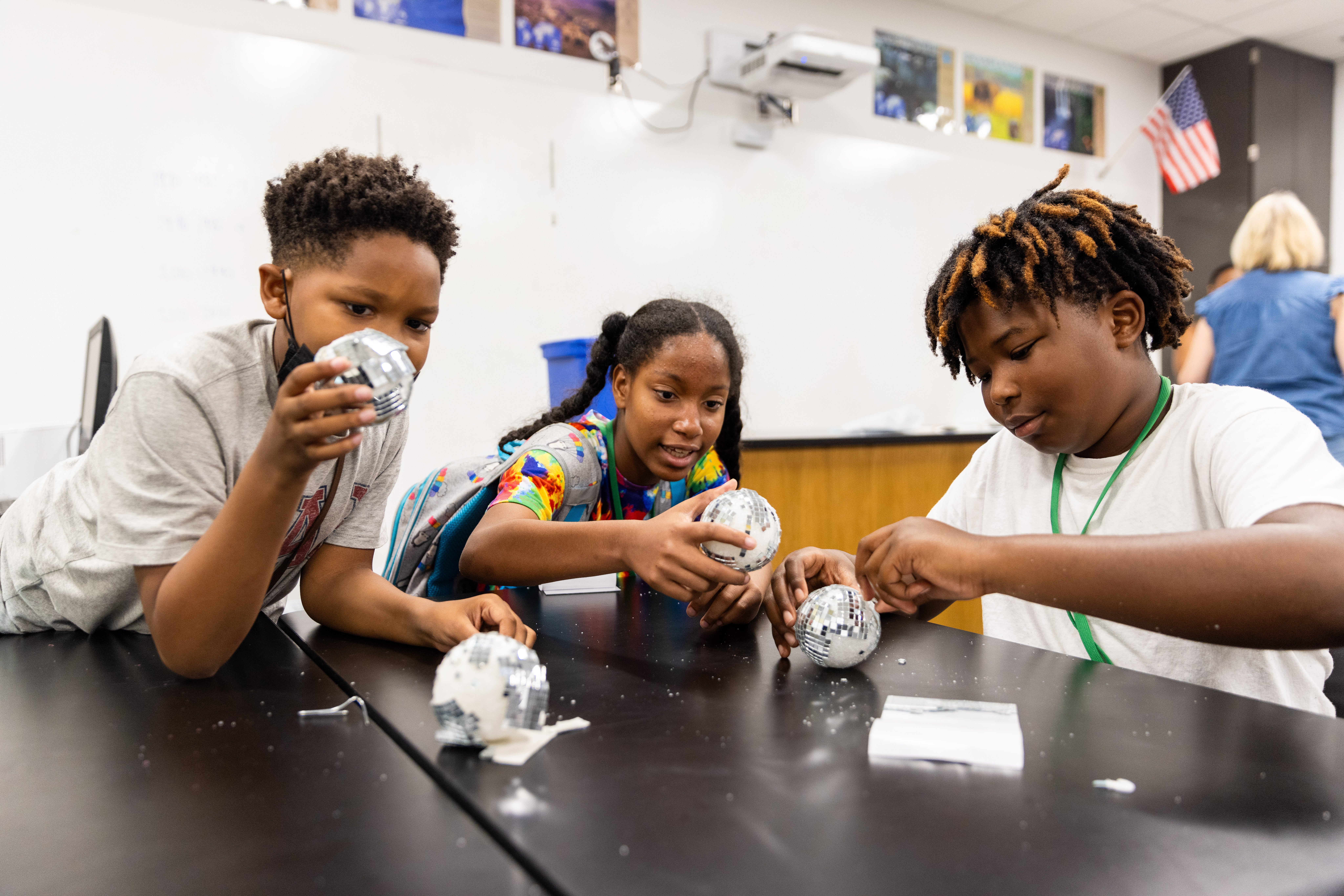Middle school students work on a foil experiment.
