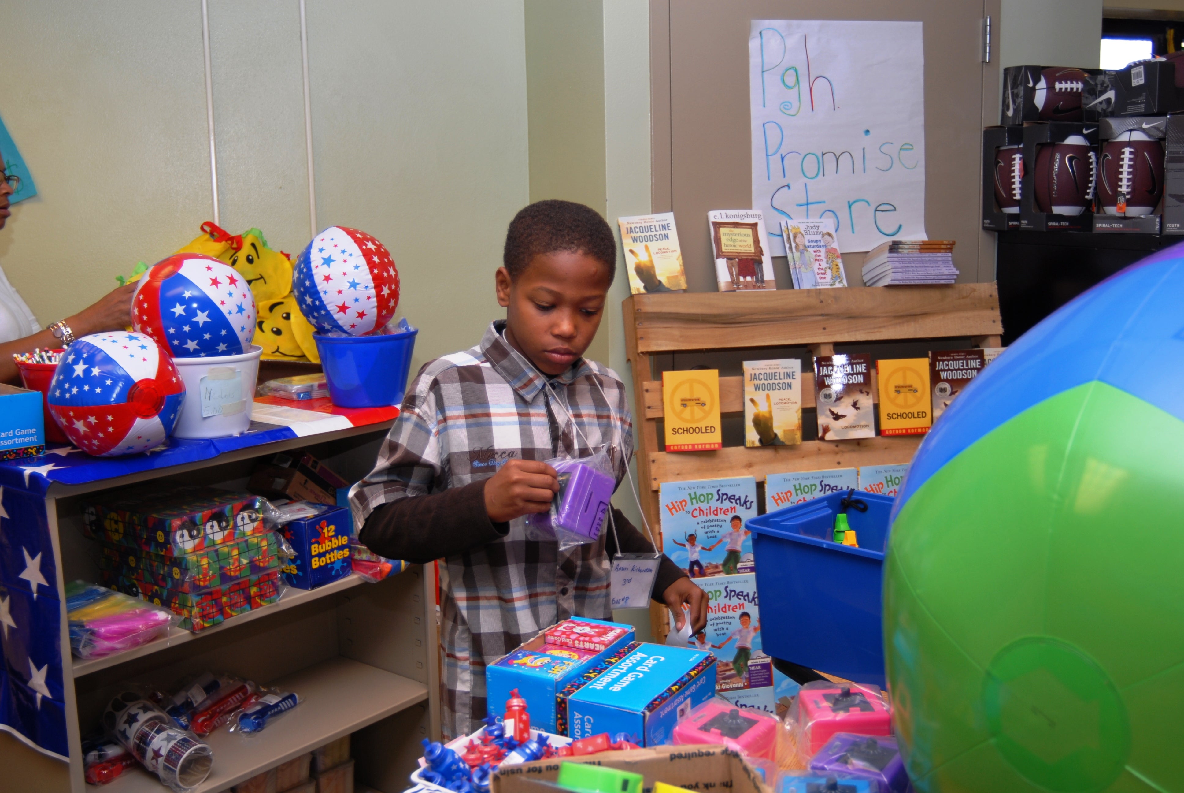 A boy mans his "Promise Store" during an afterschool program.