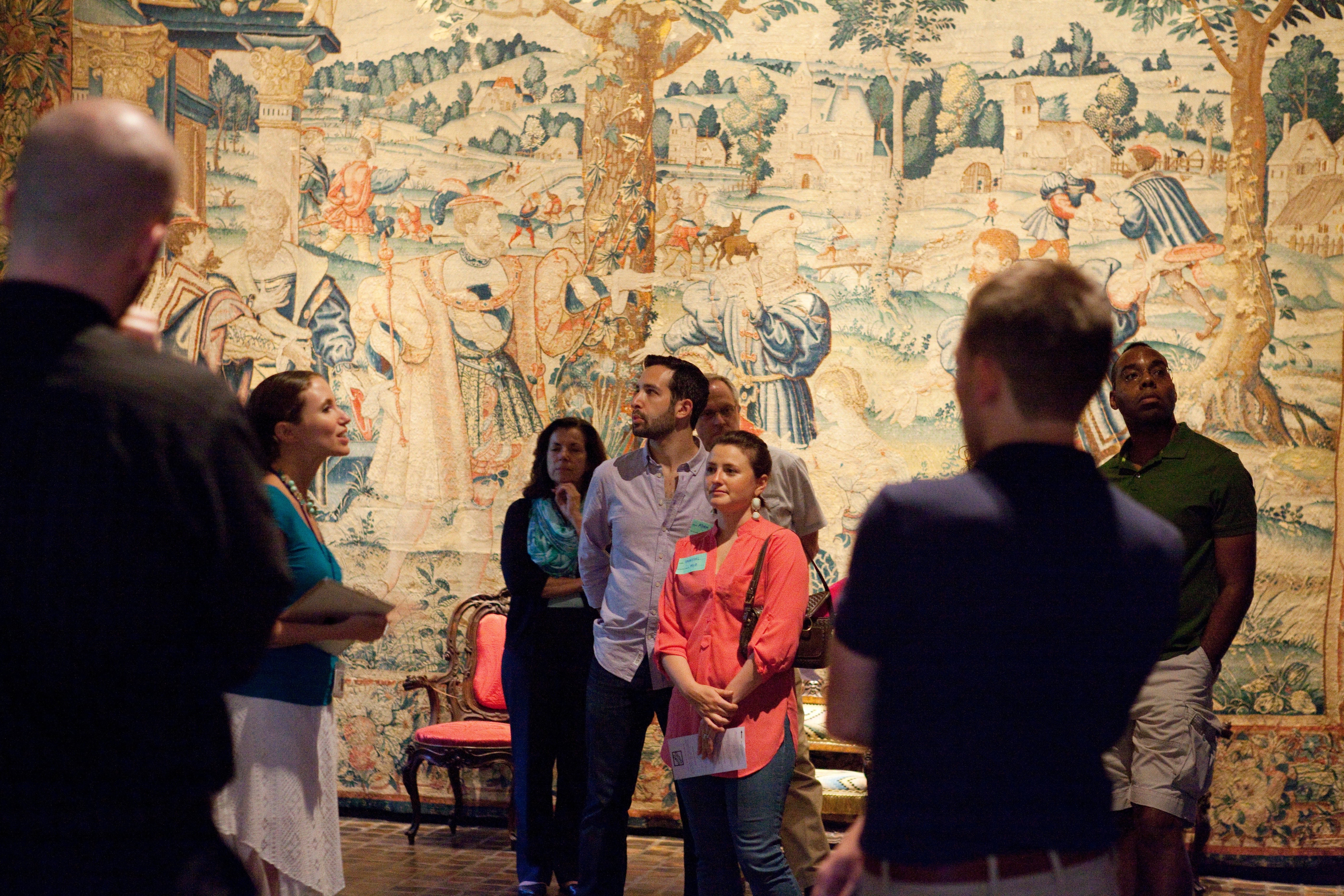 Visitors at a museum listen to the guide.