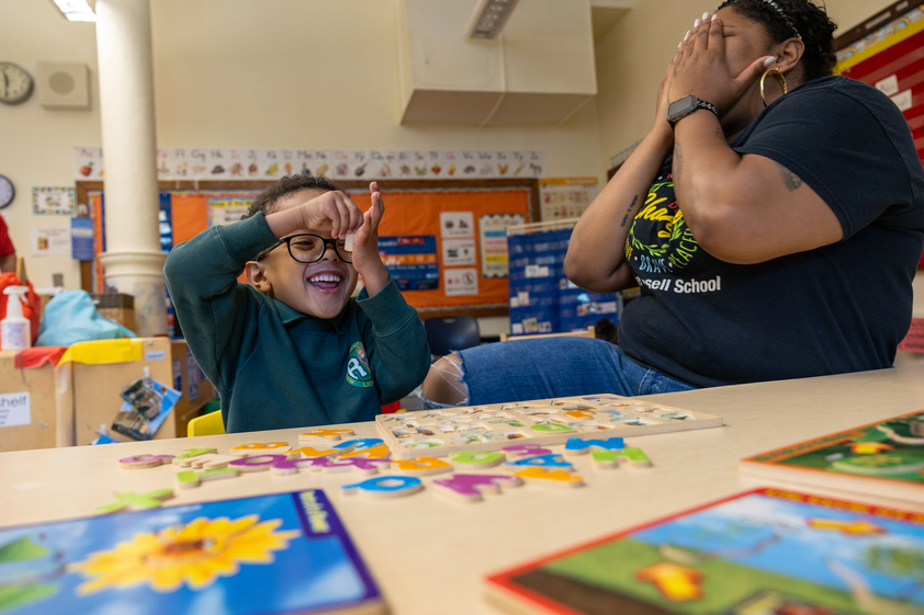 Student and teacher playing and laughing together.