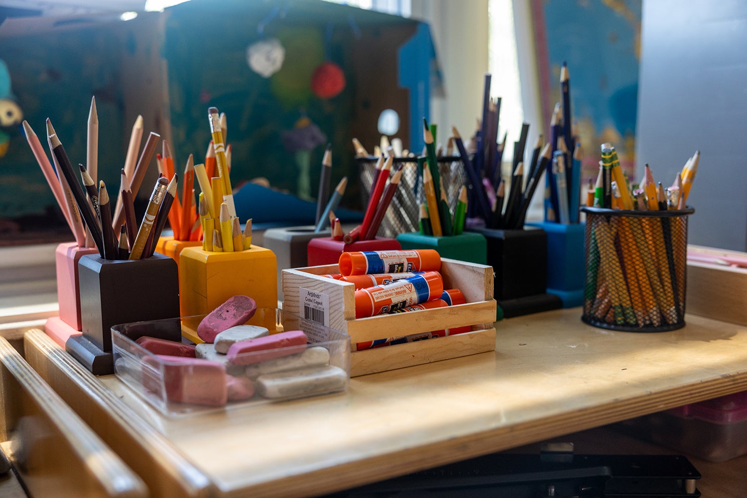 A desk of art supplies and brushes, in Boston. 