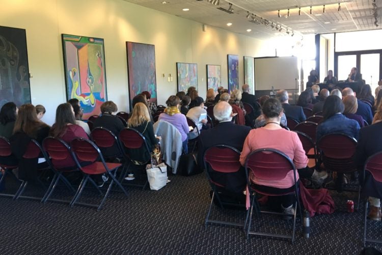 Attendees at an arts education conference listen to a speaker.