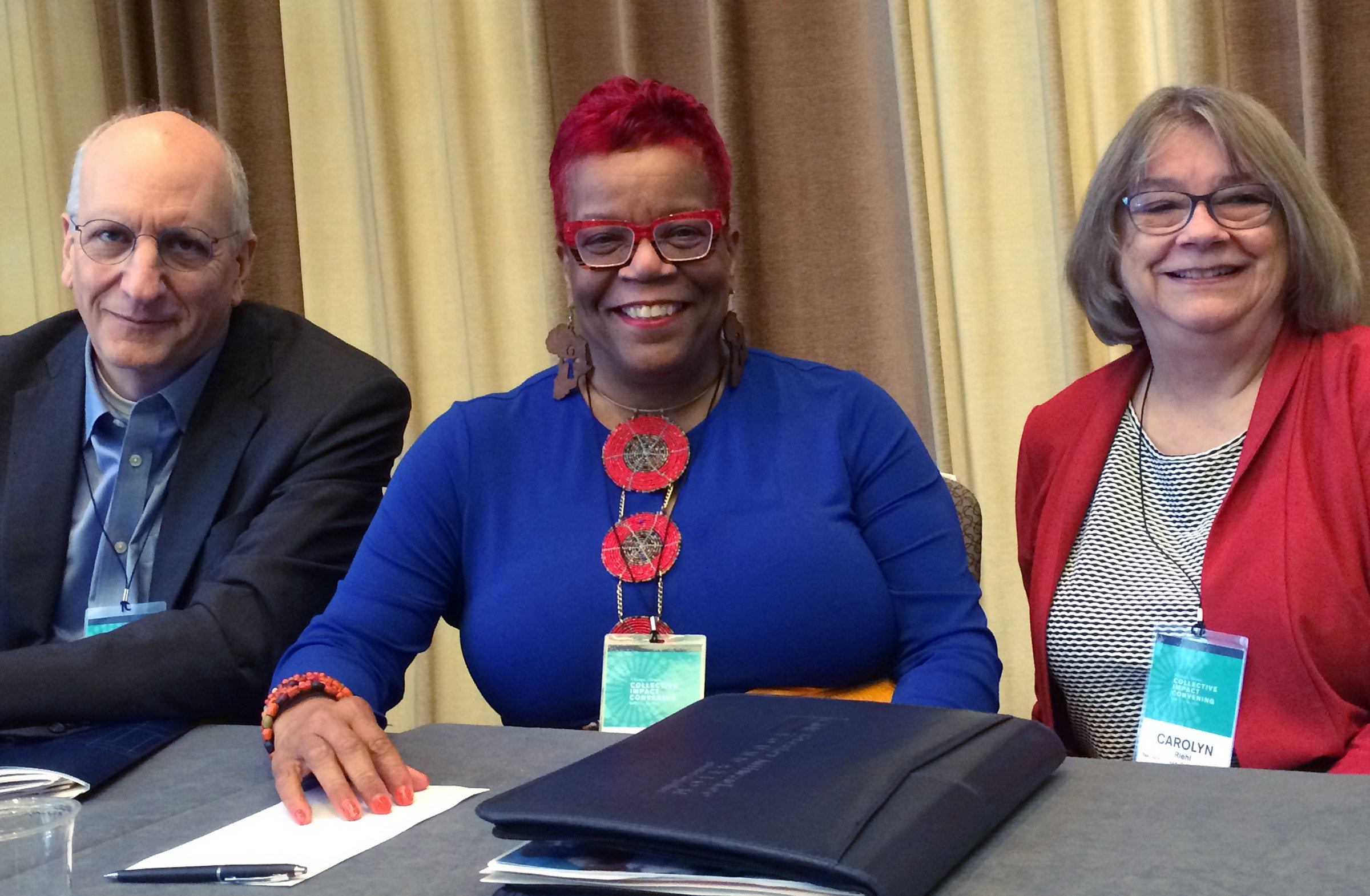 Three education leaders at a panel table.