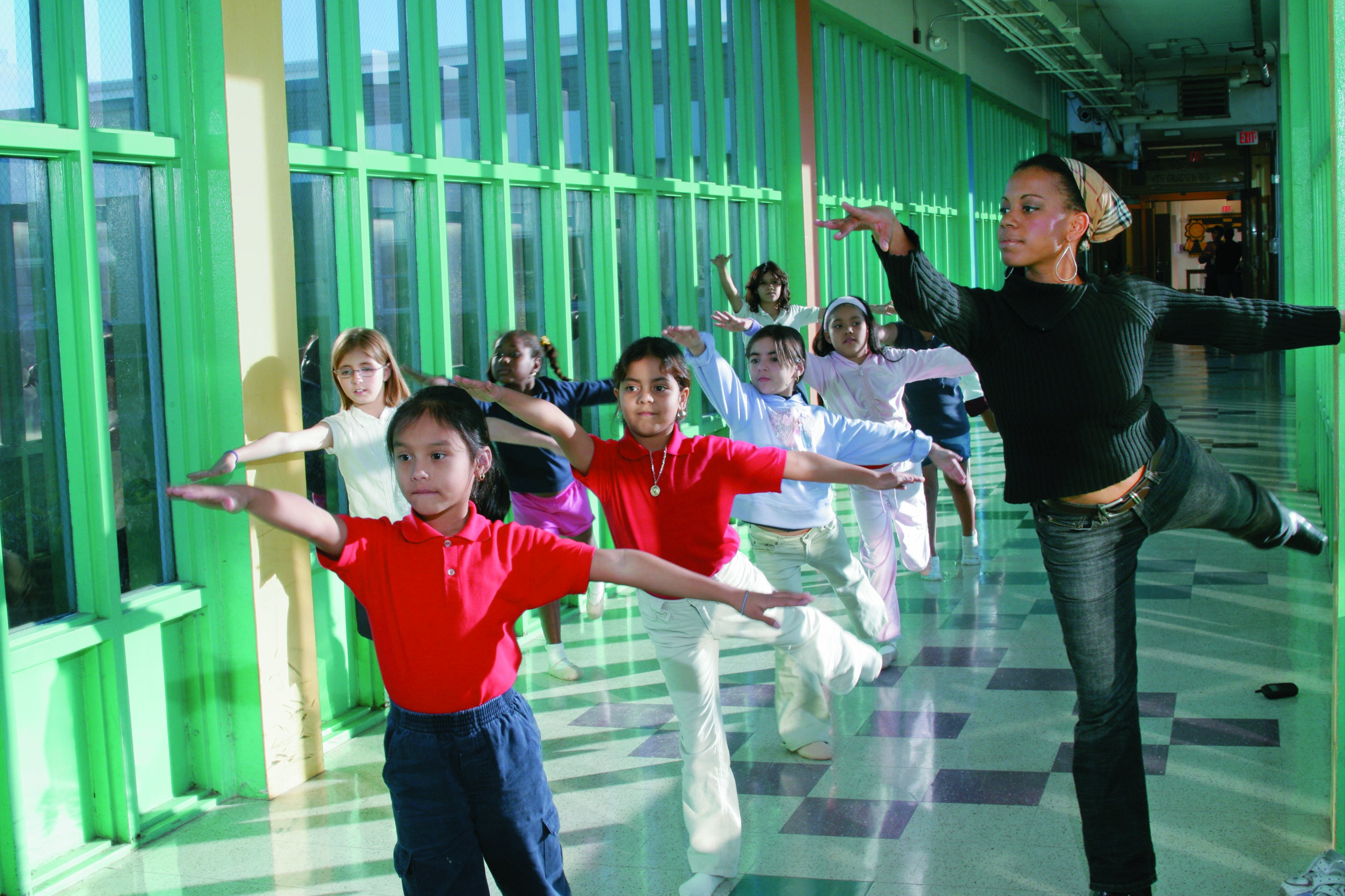 Children dancing along dance teacher.