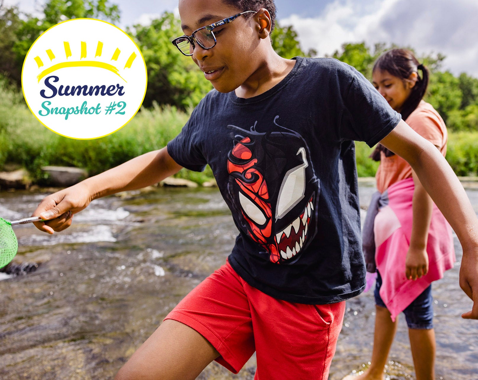 Mixed race boy and girl playing in a stream