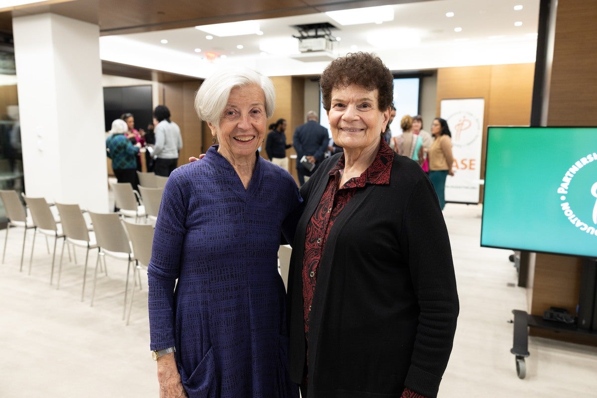 Two interviewees pose next to each other at event