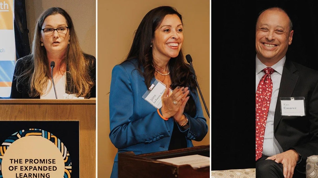 Three speakers at a podium: two women and one man