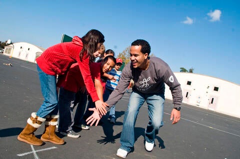 Kids and teacher playing in a school yard